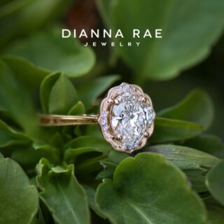 Model wearing Daisy Blossom oval diamond engagement ring in yellow gold, showcasing delicate milgrain halo and floral-inspired setting