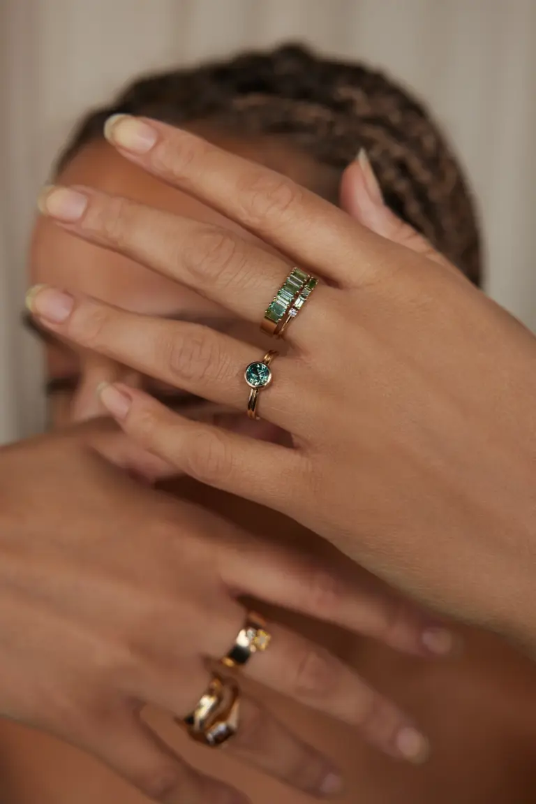 Handcrafted 14k yellow gold solitaire ring with a 1.0ct Australian bi-color sapphire, emphasizing its unique blue-green hue