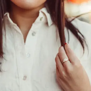 Model wearing The Luna Band diamond engagement ring with marquise and round stones, crafted in 14k rose gold with a distinctive fan-inspired silhouette