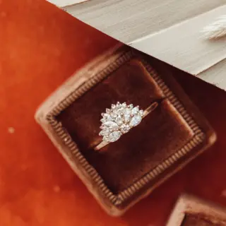 Side profile of The Luna Band engagement ring, showcasing marquise and round diamonds in a half-moon fan design set in recycled 14k gold