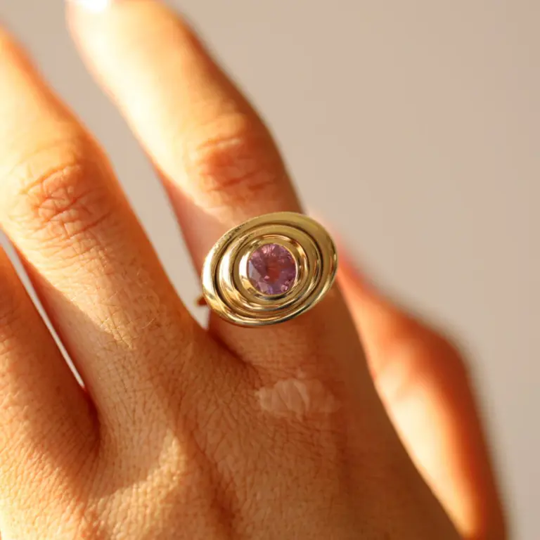 Close-up of the 1.50ct Pink Sapphire In-Orbit Ring by Marrow Fine, highlighting the GIA-certified oval pink sapphire set in 14k yellow gold.