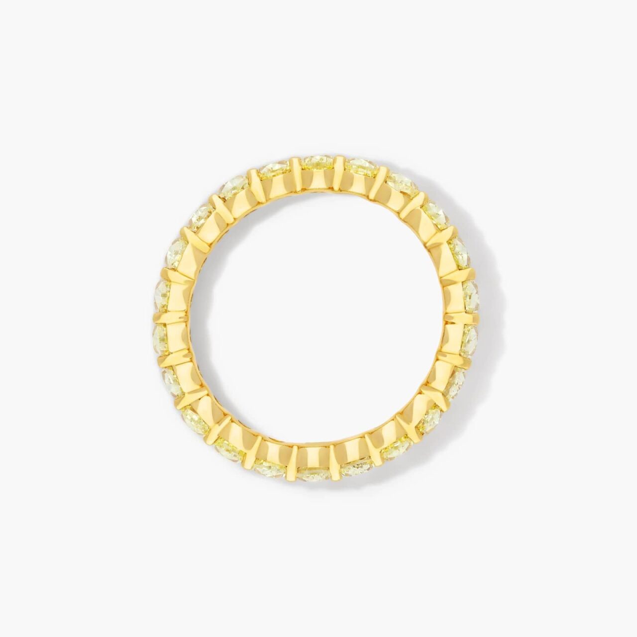 Stylish gold diamond eternity engagement ring worn by a woman, pairing timeless elegance with modern sophistication for a chic bridal look.