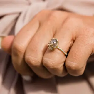 Close-up of the Destiny engagement ring, highlighting the 1.7mm pave diamond band and the unique gray, white, and red hues of the salt and pepper diamond.