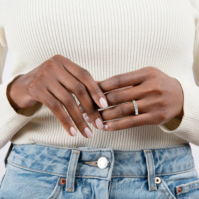 Close-up of the Seven‑Stone Trellis Ring showing seven round diamonds set in a classic trellis design on a slim gold band