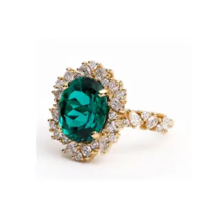 Ethical emerald and diamond cocktail ring with yellow gold setting and vintage-inspired halo