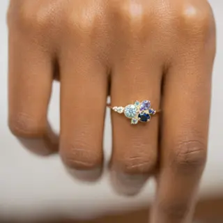 Elegant 14k gold ring featuring pale blue aquamarine flanked by white diamonds – ethereal fine jewelry