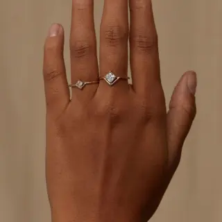Minimalist 14k gold ring featuring a princess cut diamond set in a unique nestled design by Wwake
