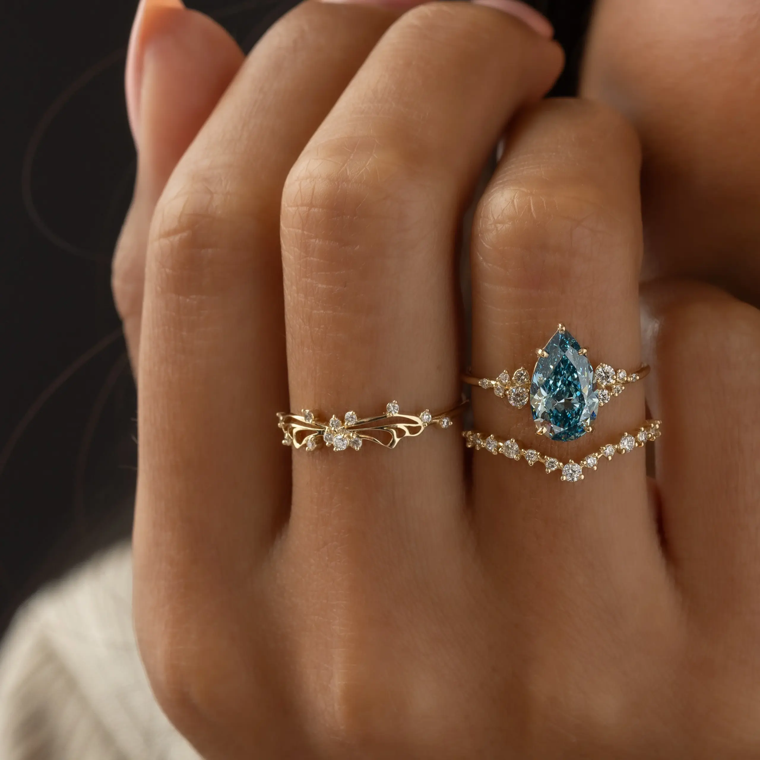 Model wearing the Diamond Small Changes Ring in 14k yellow gold, showcasing slender asymmetrical curves, airy negative‑space detail, and soft feminine elegance.