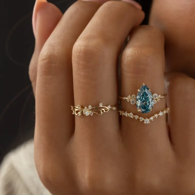 Model wearing the Diamond Small Changes Ring in 14k yellow gold, showcasing slender asymmetrical curves, airy negative‑space detail, and soft feminine elegance.