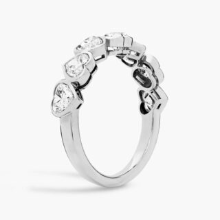 Heart-shaped diamond engagement ring on woman’s hand, elegant and romantic symbol of love, proposal, and lifelong commitment.