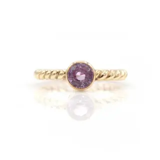 14K gold pink sapphire ring by Symmetry Jewelers, featuring a round-cut pink sapphire in a classic setting.