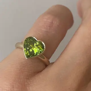 Large peridot heart ring bezel‑set in yellow gold, playful yet classic