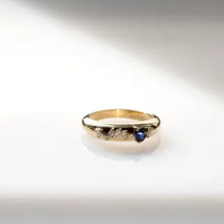 Side profile of the Demi Demi Plus 8 Ring highlighting its sleek design and the vibrant blue sapphire.