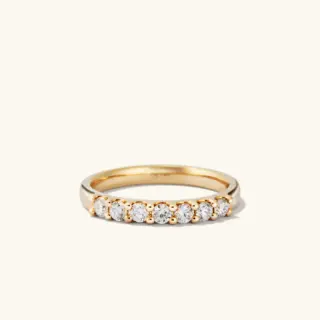 Stackable Bold Diamond Half Eternity Ring by Mejuri, crafted in 14k yellow gold with seven round-cut diamonds, perfect for daily wear.