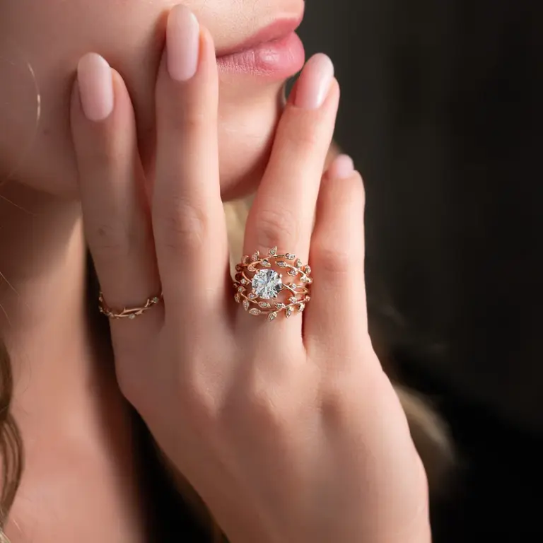 Close-up of the Jacket Emily wedding band showcasing intricate vine detailing and sparkling accent diamonds set in 14K white gold.