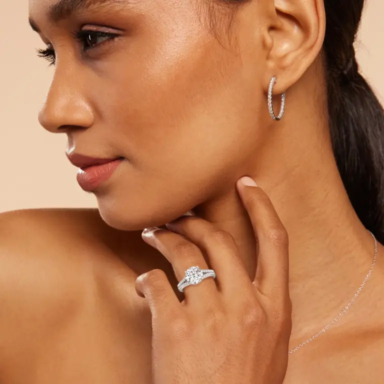 Lab-grown diamond engagement ring worn on hand, showing elegant pavé detailing and modern halo design in a sleek white gold setting.