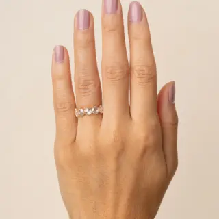 Close-up of textured yellow gold wedding band with five rose‑cut diamonds set with milgrain edging and subtle dark rhodium accents