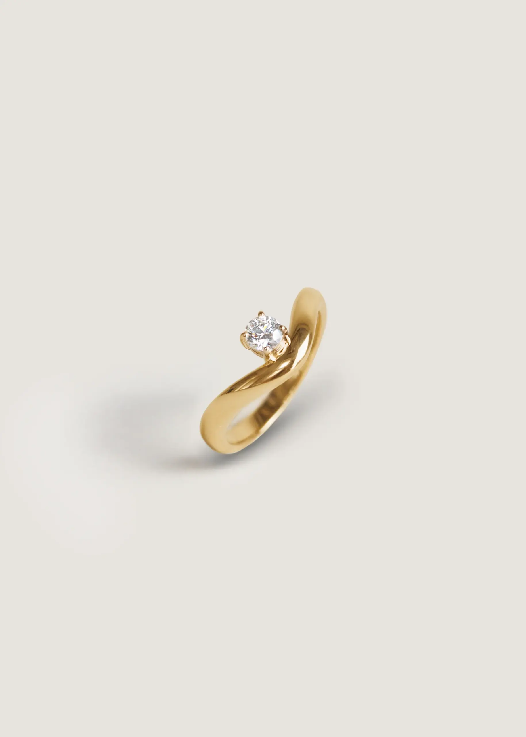Elegant gold curved diamond ring for women by Kinn Studio, sustainable fine jewelry with lab-grown diamond