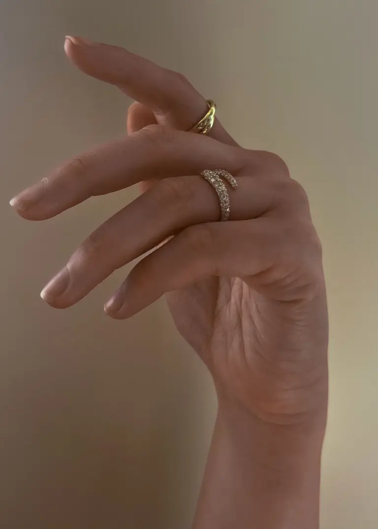 Side profile of Kinn Studio’s wrap-around diamond ring—wide front tapering elegantly toward the back.