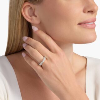 Heart-shaped diamond engagement ring on woman’s finger, romantic and elegant ring symbolizing love and commitment