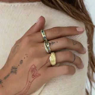 Sapphire half eternity ring in 14k yellow gold with channel-set round blue sapphires, modern and timeless stacking band.