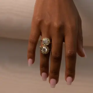 Spotlight Ring by Audry Rose featuring a 1.3 ct round brilliant diamond in an organic bezel setting with 14 side diamonds.