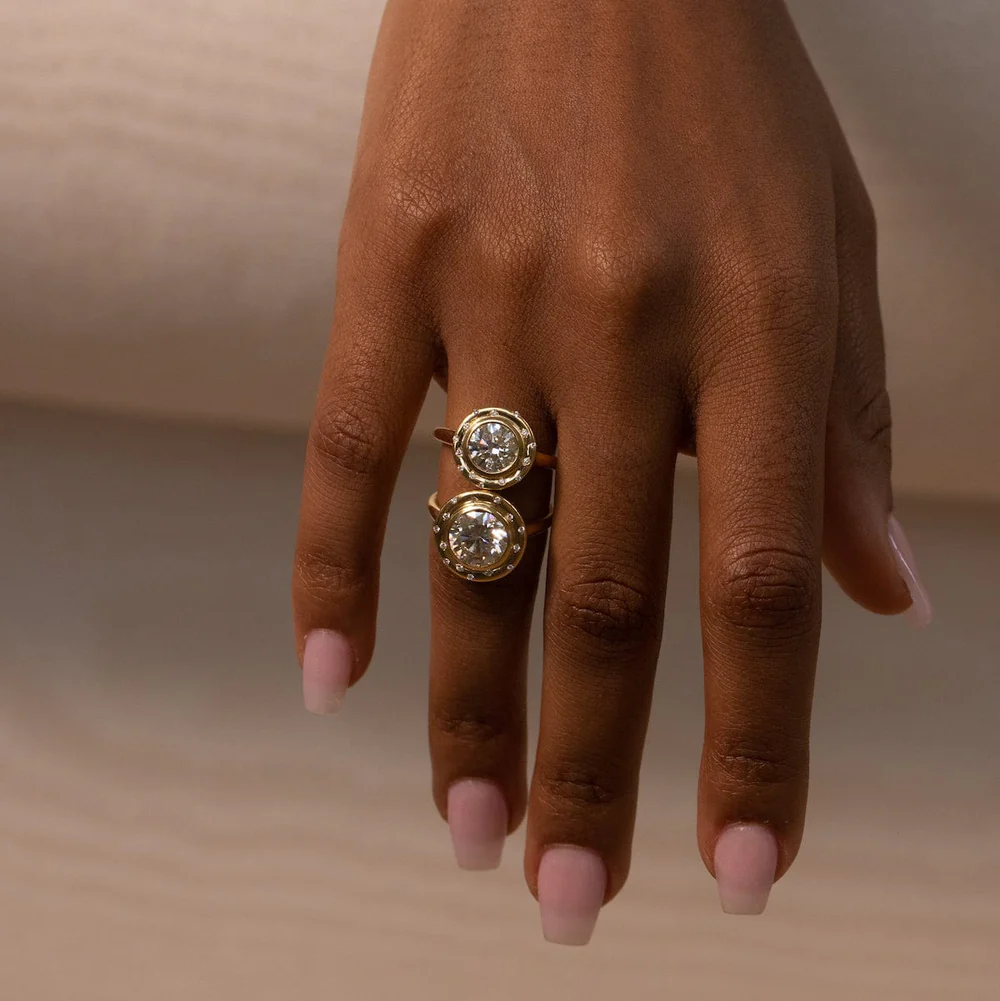 Spotlight Ring by Audry Rose featuring a 1.3 ct round brilliant diamond in an organic bezel setting with 14 side diamonds.