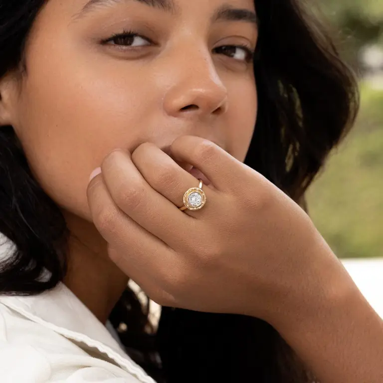 Side view of the Spotlight Ring with a unique starry bezel and 14 small white diamonds on the band.