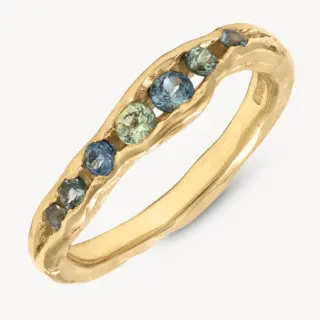 Gold ring with blue sapphires in a channel setting.