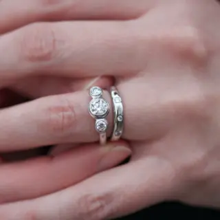 Lifestyle image of the Three Stone Diamond Engagement Ring worn on the hand, emphasizing its elegant design and sparkling diamonds