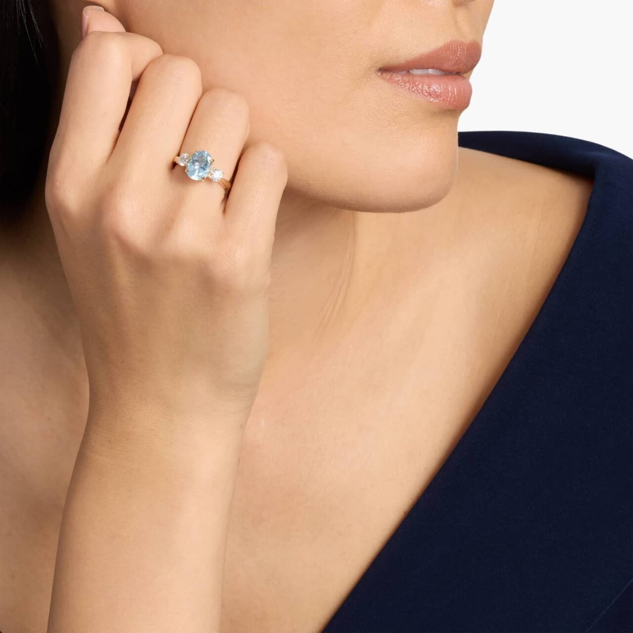 4K yellow gold ring with 10×8 mm oval aquamarine center and round diamond accents