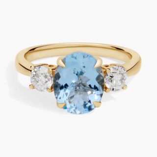 Oval aquamarine ring in 14K yellow gold with two round diamond sidestones (0.62 ctw)