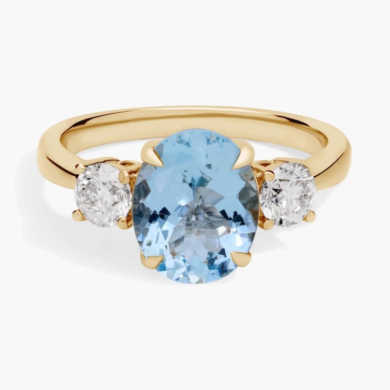 Oval aquamarine ring in 14K yellow gold with two round diamond sidestones (0.62 ctw)