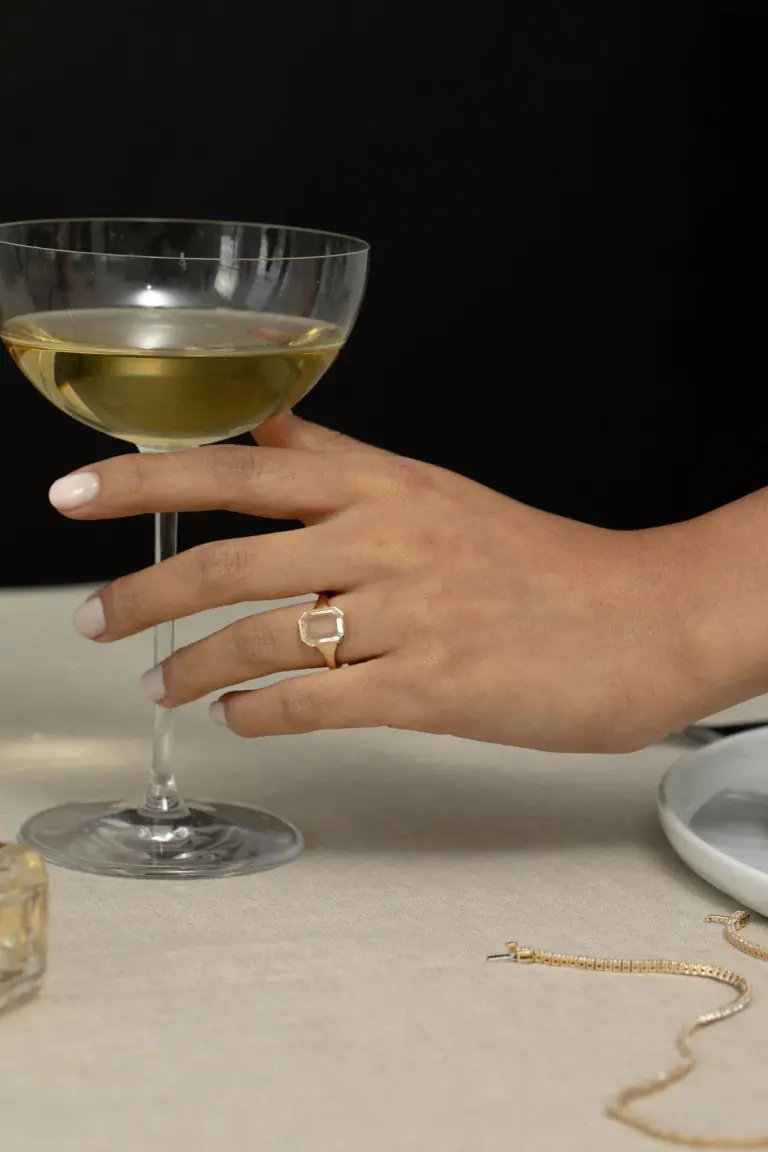 Model wearing the Maren Portrait Bezel Emerald Ring, emphasizing its minimalist design and vibrant green hue.