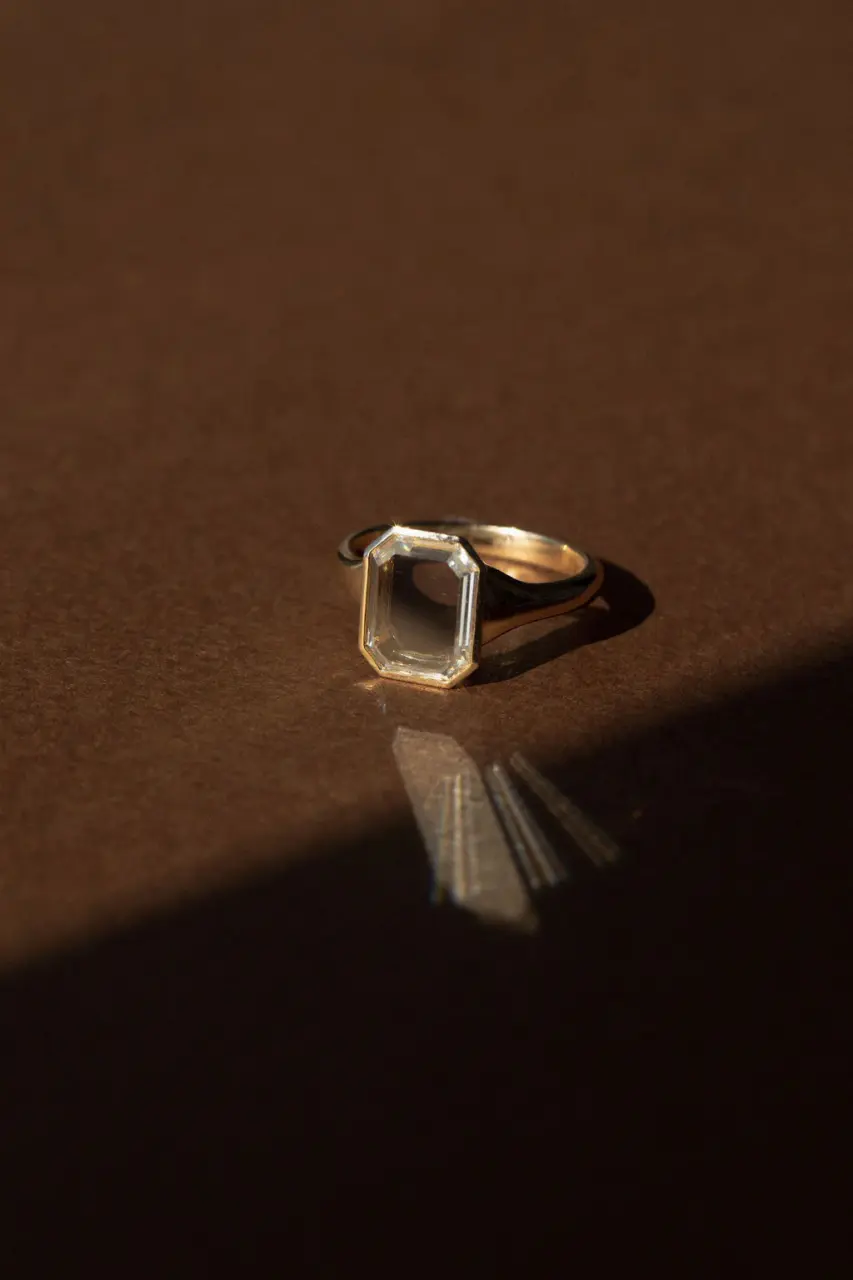 Close-up of the Maren Portrait Bezel Emerald Ring showcasing a 2.50 ct portrait-cut emerald set in a solid 14k gold bezel.