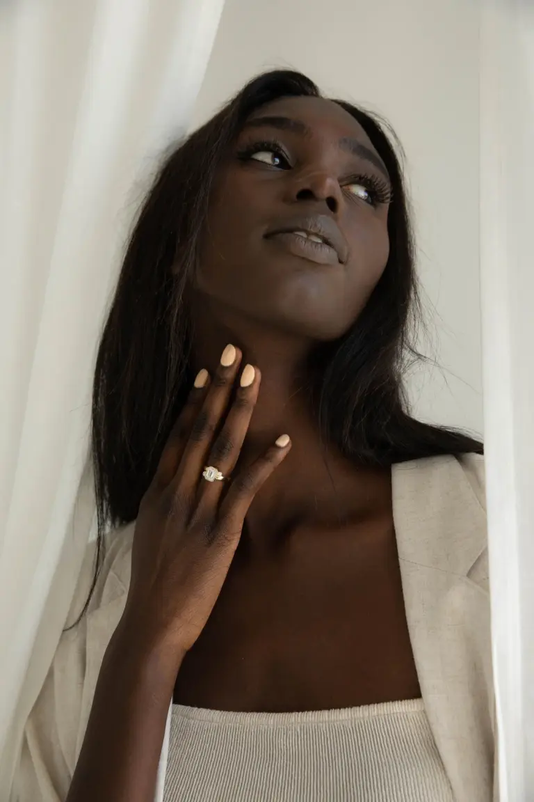 The Indigo Emerald Ring worn on hand, illustrating its bold design and the radiant emerald-cut center stone set in 14k gold.