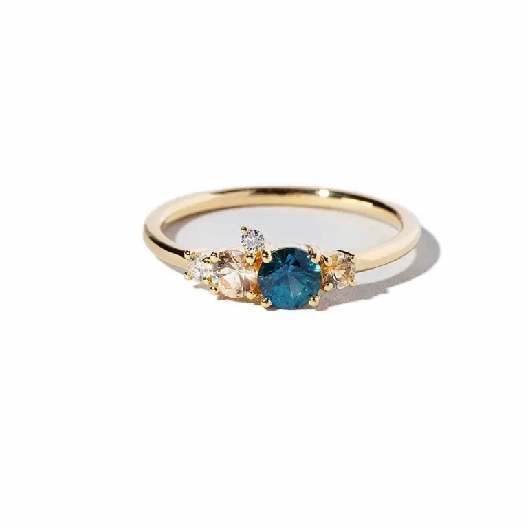 Mociun Aster Ring in 18K yellow gold with Montana blue sapphire, peach sapphire accents, and diamonds
