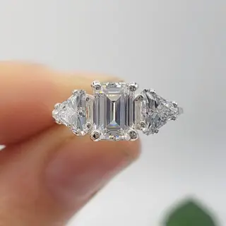 Shahla Karimi 3‑Stone Ring with emerald‑cut center and cut‑corner triangle side diamonds in yellow gold