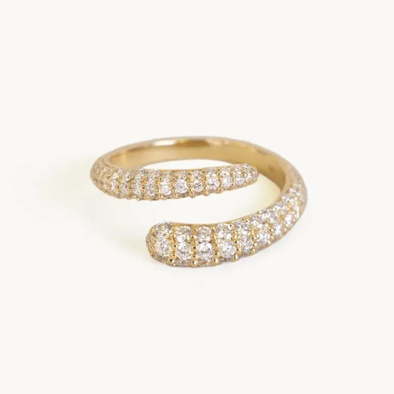 Pavé wrap ring on pinky finger by Kinn—bold diamond statement in recycled 14K gold.