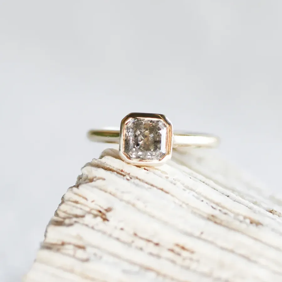 JP Gild 14 kt recycled yellow gold ring with 1.15 ct salt and pepper Asscher‑cut diamond in an open‑bottom cathedral bezel