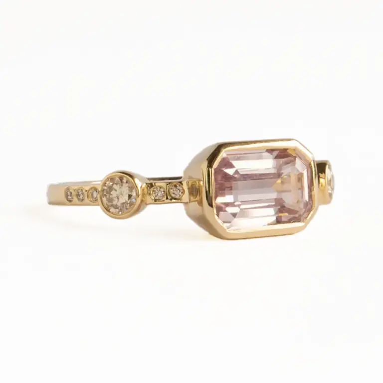Hikaru Ring No. 10 on hand: shows softly glowing pink sapphire and sparkling champagne diamond details in recycled gold