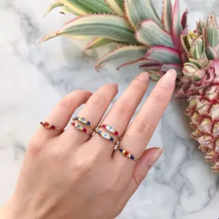 Aquamarine and Sapphire triplet engagement ring worn on a hand, highlighting its elegant sparkle and sophisticated design in natural lighting