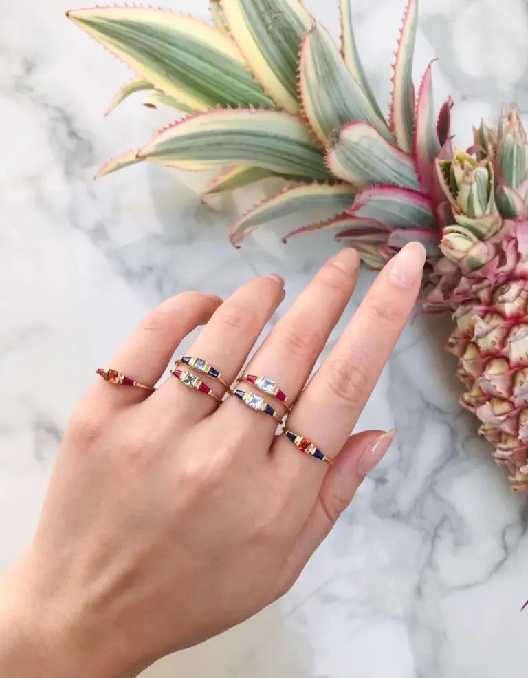 Aquamarine and Sapphire triplet engagement ring worn on a hand, highlighting its elegant sparkle and sophisticated design in natural lighting