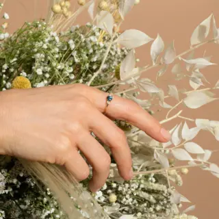 Cluster ring by Mociun featuring 0.47 ct Montana blue sapphire, peach sapphires, and diamonds in 18K gold