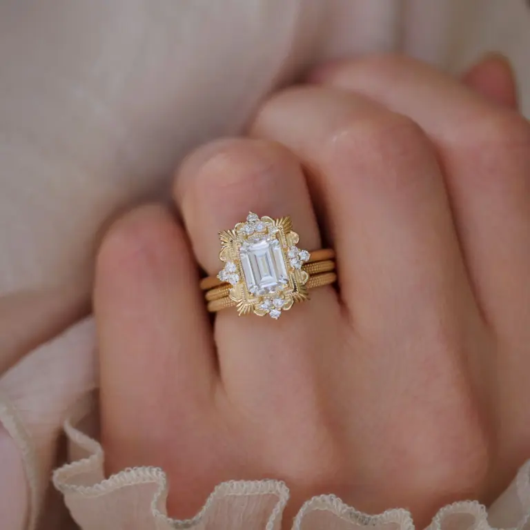 Elegant moissanite engagement ring with diamond detailing and intricate Florentine design