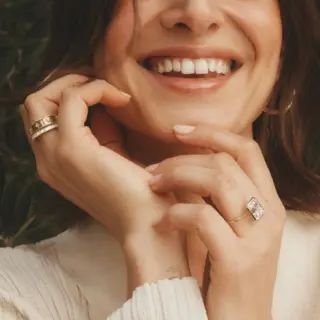 Vintage-inspired starburst engagement ring with round center diamond in yellow gold band