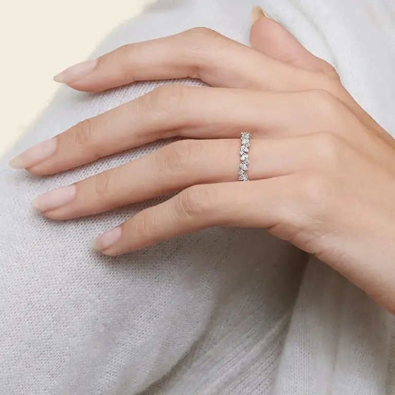 Detailed view of an Olivetta ring expertly crafted in 18K white gold, with F/G color, SI clarity lab-grown pearls and round diamonds arranged across the upper band for a delicate half‑coverage sparkle