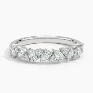 Side-angle image of the Olivetta Half Coverage ring in 18K white gold, revealing its 3.3 mm band width and a graceful mix of prong-set round and pear lab-grown diamonds creating a romantic, shimmering effect