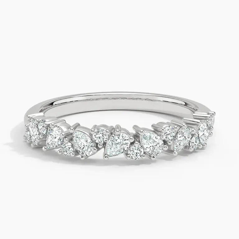 Side-angle image of the Olivetta Half Coverage ring in 18K white gold, revealing its 3.3 mm band width and a graceful mix of prong-set round and pear lab-grown diamonds creating a romantic, shimmering effect