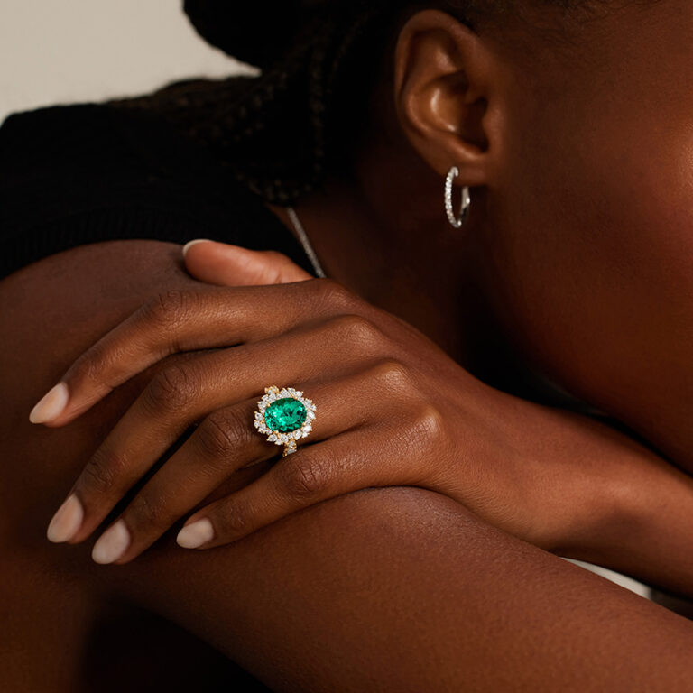 Brilliant Earth statement ring featuring green lab emerald and lab diamonds in floral cluster design